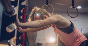 A woman preparing to powerlift a barbell, symbolizing the strength and resilience of neurodiverse individuals.