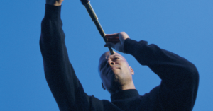 Man looking through a telescope, symbolizing how personal bias and perception shape the way we view the world.